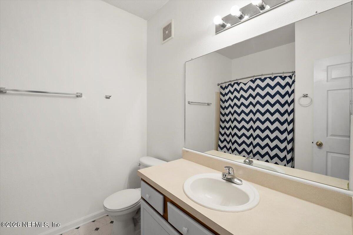 3641 Kirkpatrick Circle, Unit 141 Jacksonville, FL 32210 - Photo 18 of 25 a bathroom with a sink toilet and a mirror