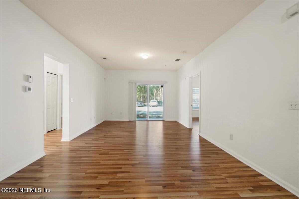 3641 Kirkpatrick Circle, Unit 141 Jacksonville, FL 32210 - Photo 8 of 25 a view of empty room with wooden floor and window