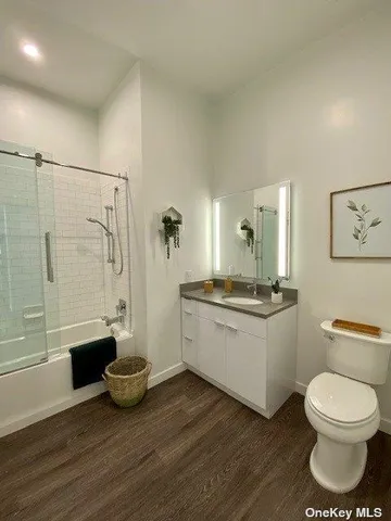 a bathroom with a sink a toilet and a shower