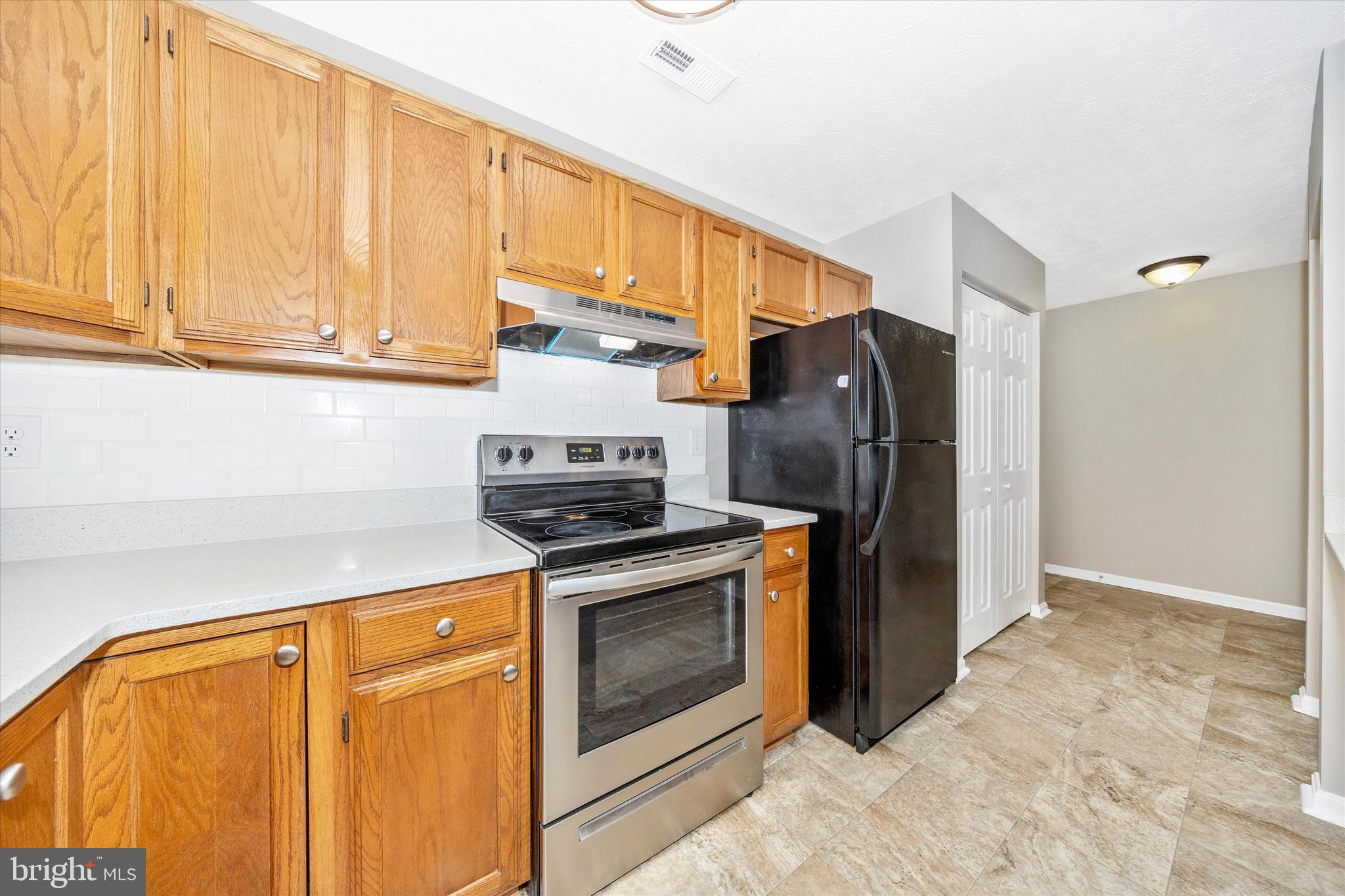 2112 Whitehall Road, Unit 1C Frederick, MD 21702 - Photo 11 of 33 a kitchen with stainless steel appliances granite countertop a refrigerator a stove and a sink