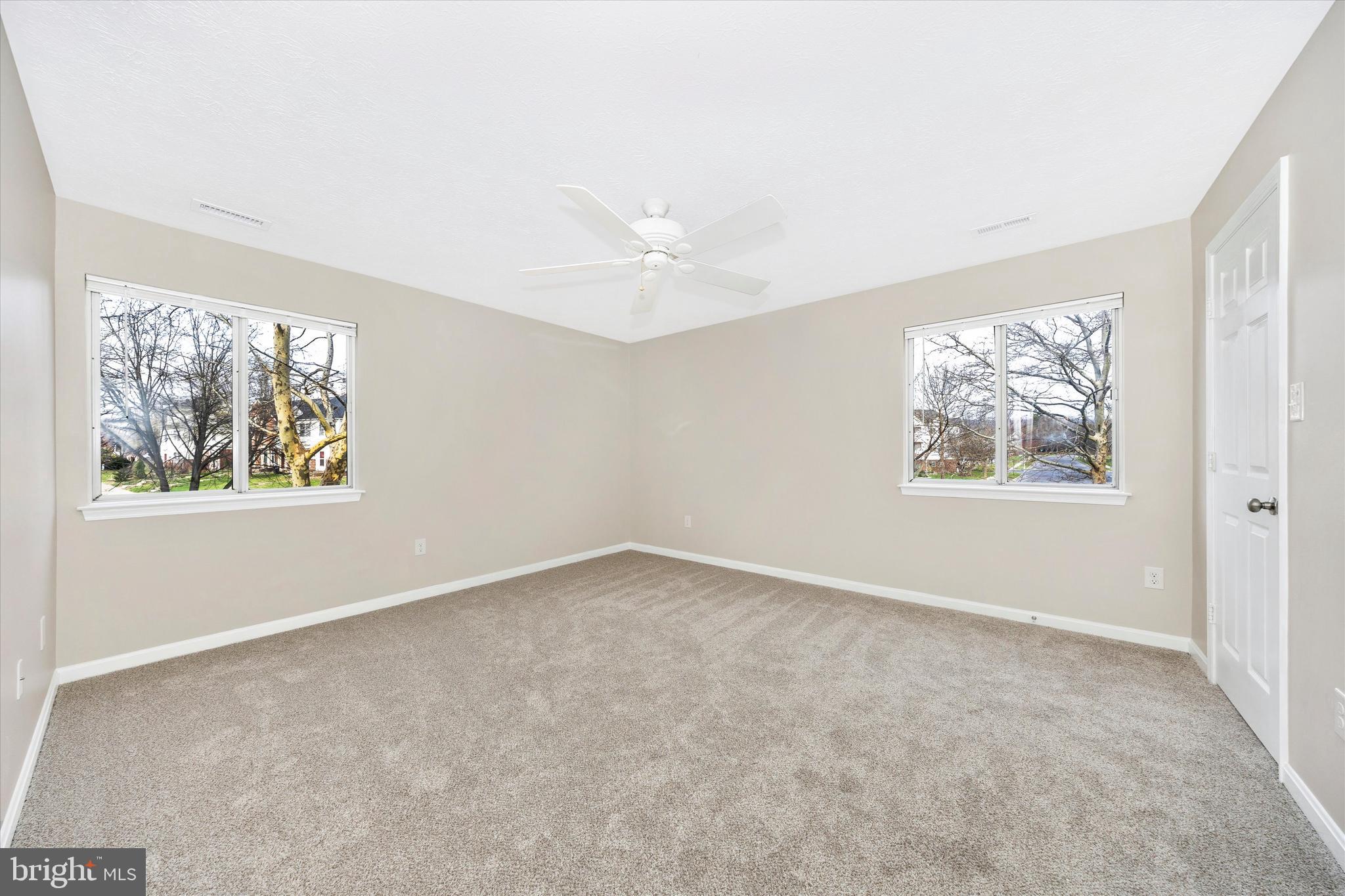 2112 Whitehall Road, Unit 1C Frederick, MD 21702 - Photo 16 of 33 an empty room with windows and chandelier fan