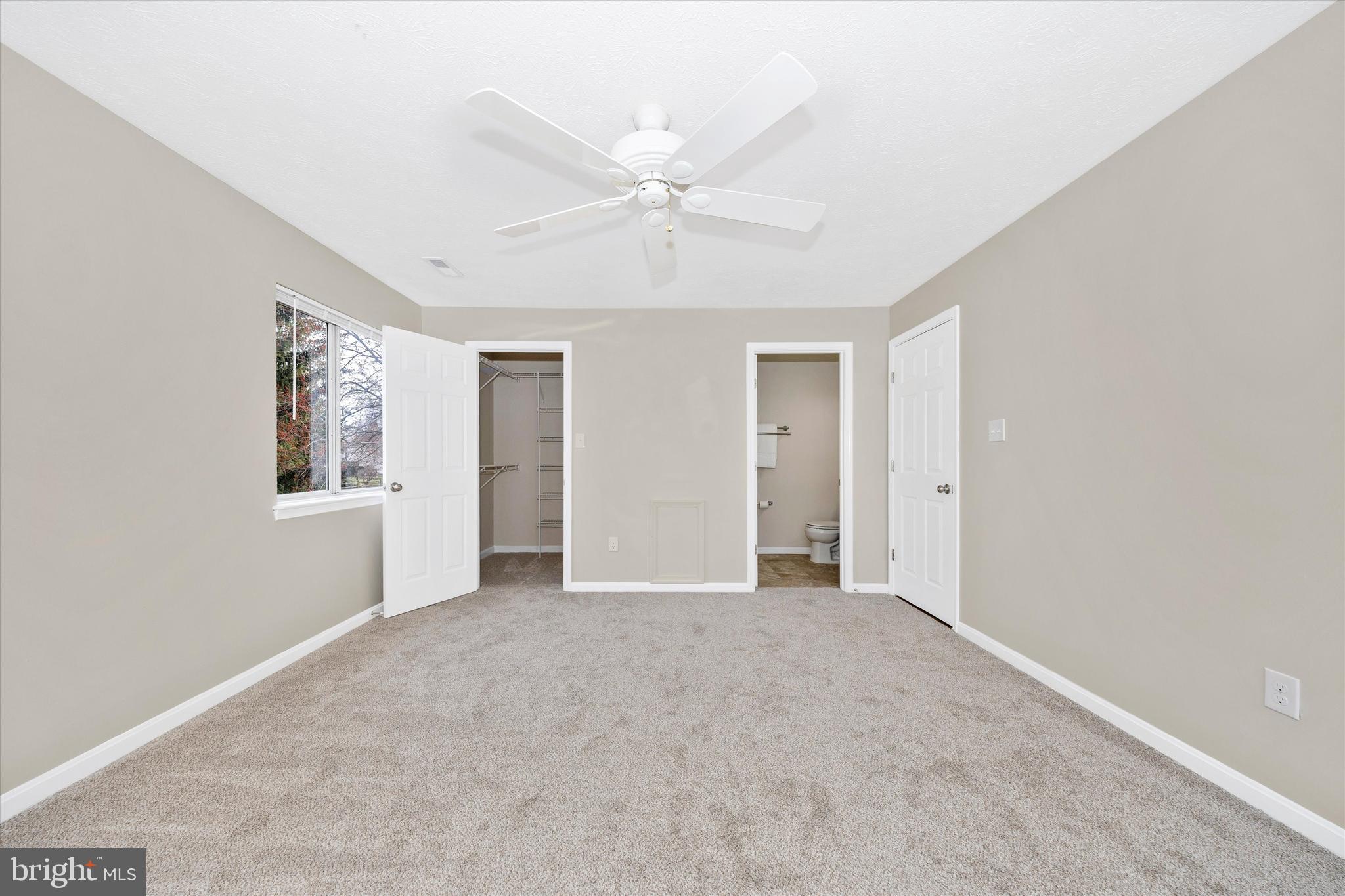 2112 Whitehall Road, Unit 1C Frederick, MD 21702 - Photo 18 of 33 a view of an empty room with window and chandelier fan
