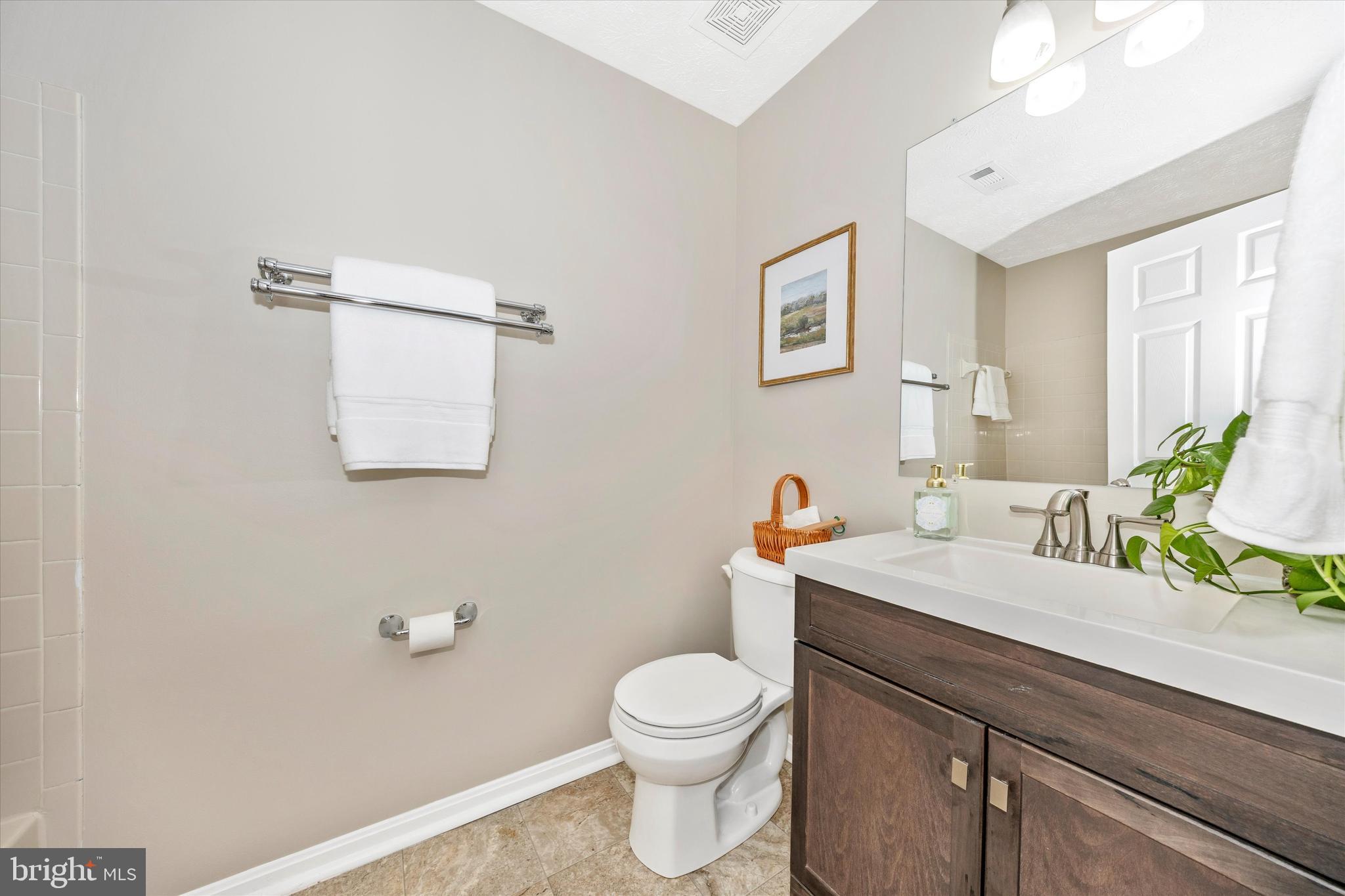 2112 Whitehall Road, Unit 1C Frederick, MD 21702 - Photo 20 of 33 a bathroom with a toilet a sink and mirror