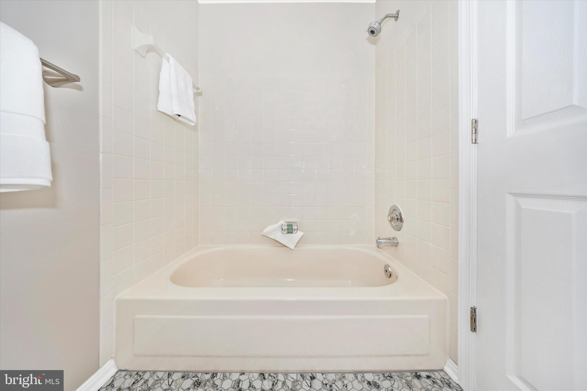 2112 Whitehall Road, Unit 1C Frederick, MD 21702 - Photo 25 of 33 a white bath tub sitting next to a white sink