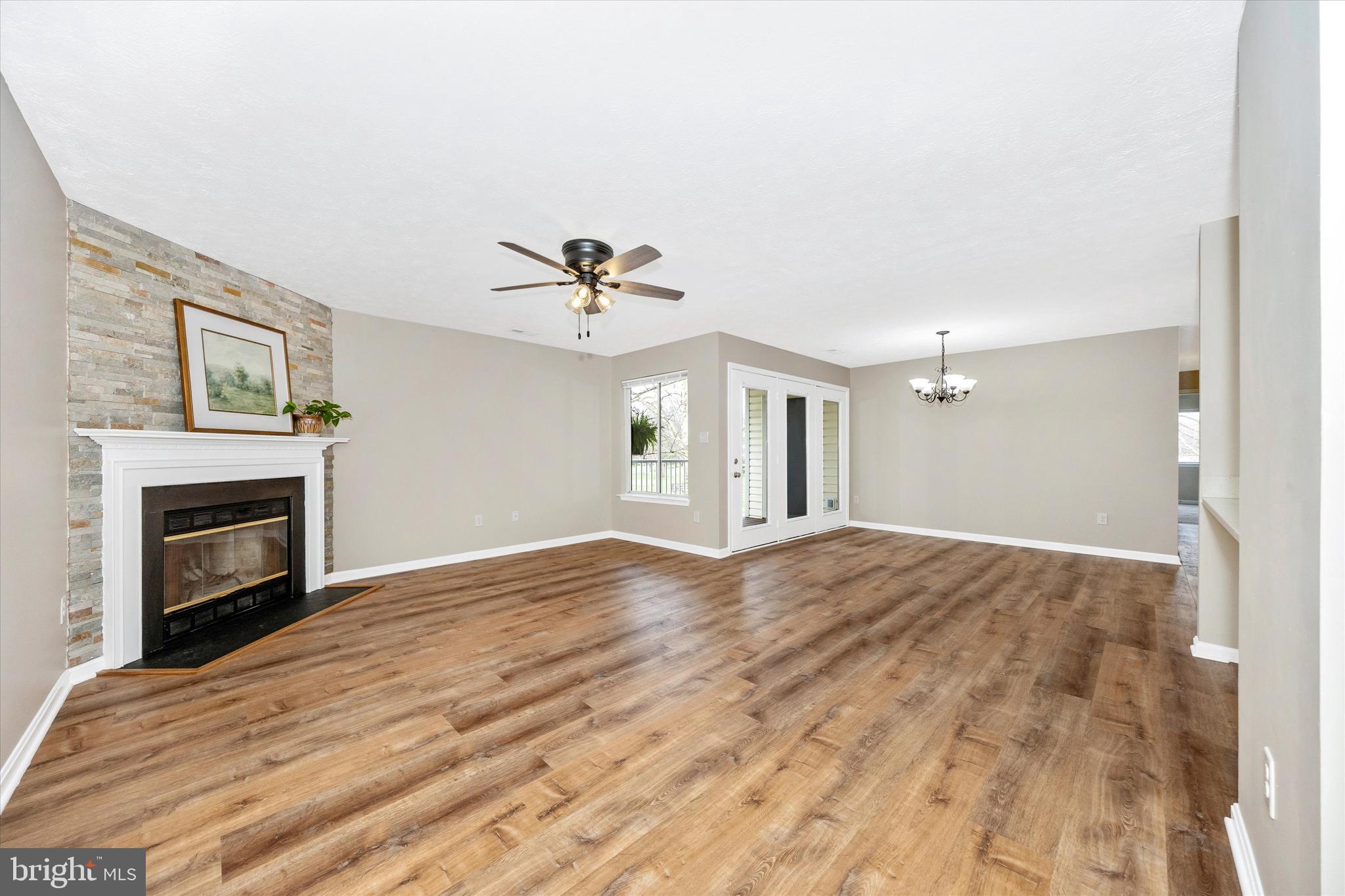2112 Whitehall Road, Unit 1C Frederick, MD 21702 - Photo 7 of 33 a view of empty room with fireplace and wooden floor