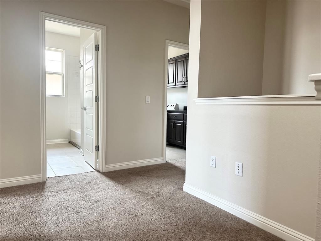 6814 East Riverside Drive, Unit 26 Austin, TX 78741 - Photo 12 of 21 A well-maintained interior space with soft carpeting and light-filled rooms.