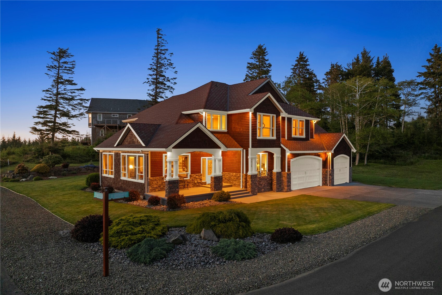 3015 Lighthouse Keepers Road Ilwaco, WA 98624 - Photo 1 of 40 a front view of a house with garden