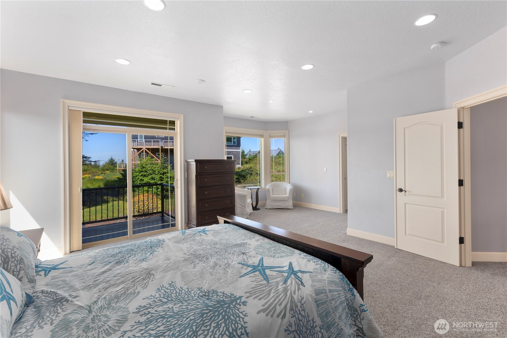 3015 Lighthouse Keepers Road Ilwaco, WA 98624 - Photo 19 of 40 a bedroom with a bed and glass door