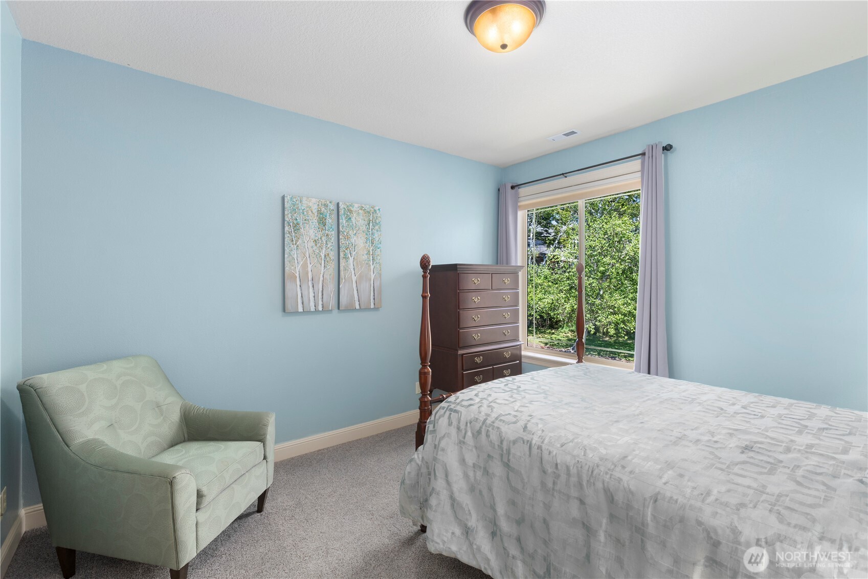 3015 Lighthouse Keepers Road Ilwaco, WA 98624 - Photo 32 of 40 a bedroom with a bed and a chair