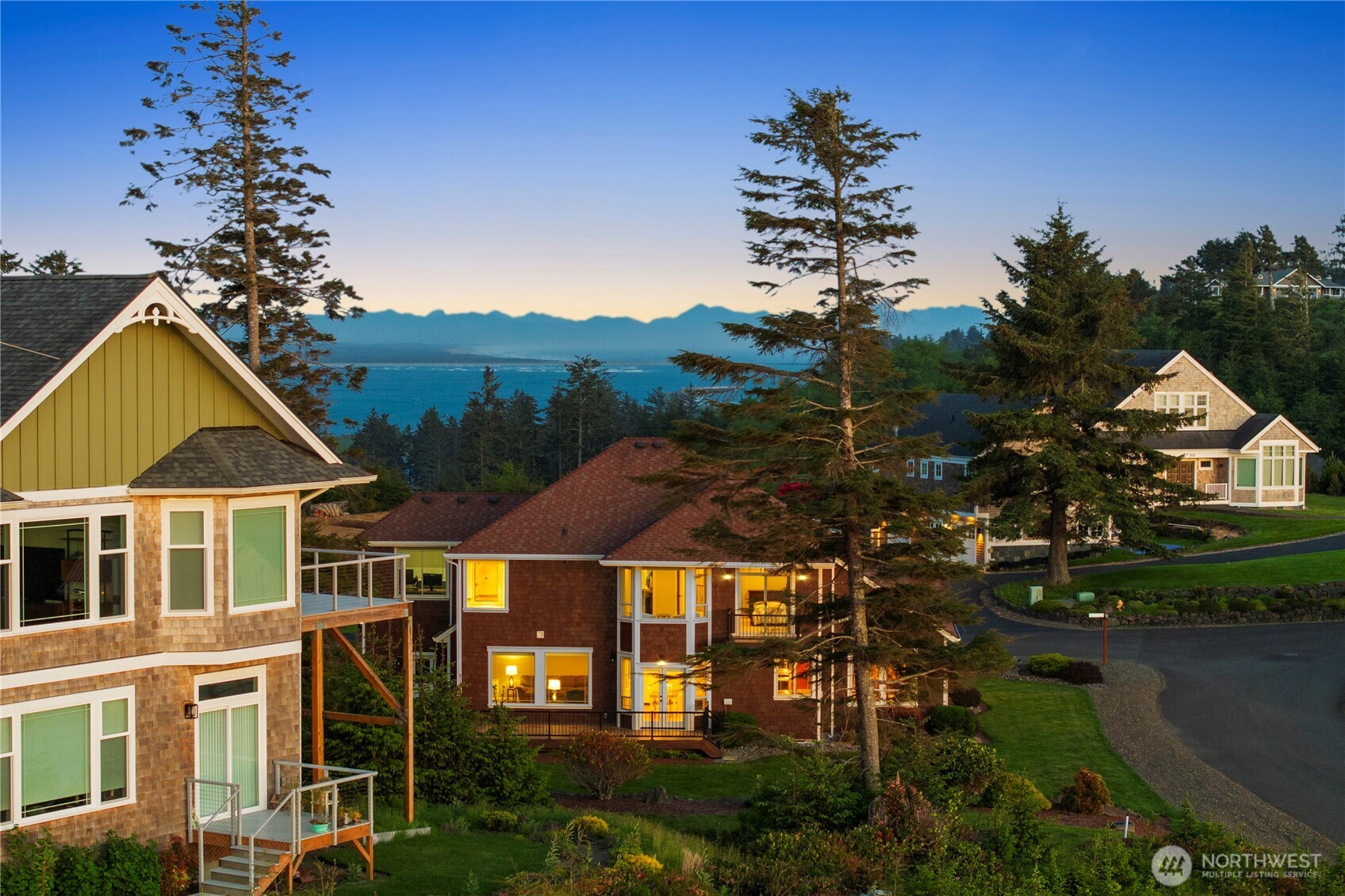 3015 Lighthouse Keepers Road Ilwaco, WA 98624 - Photo 5 of 40 a front view of a house with a yard and potted plants