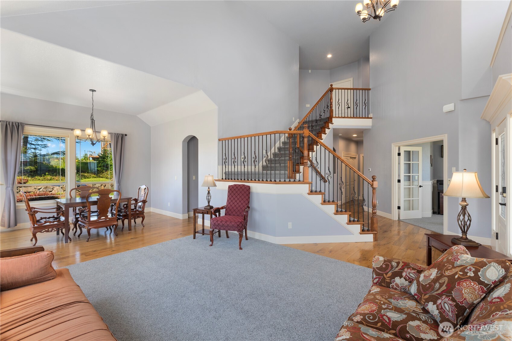 3015 Lighthouse Keepers Road Ilwaco, WA 98624 - Photo 8 of 40 a living room with furniture a dining table and a chandelier