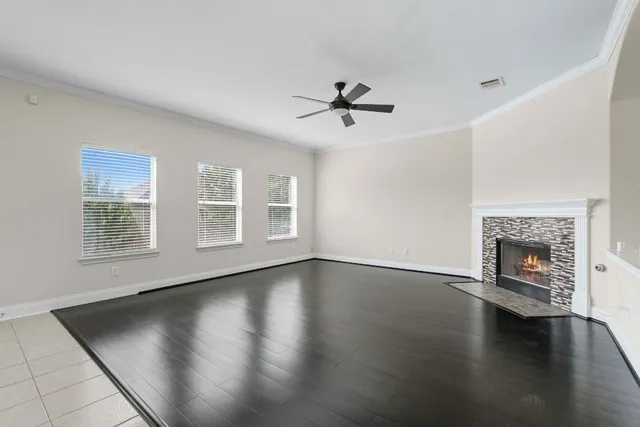 a view of empty room with wooden floor and fireplace