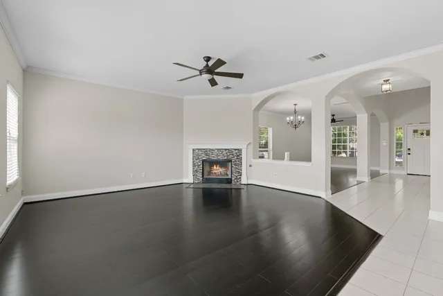 an empty room with wooden floor and fireplace