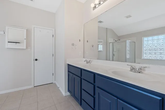 a bathroom with a double vanity sink mirror and double