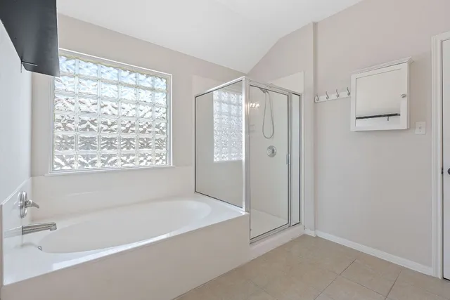 a bathroom with a bathtub and a shower