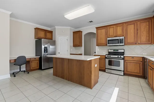 a kitchen with stainless steel appliances a stove a sink and a microwave
