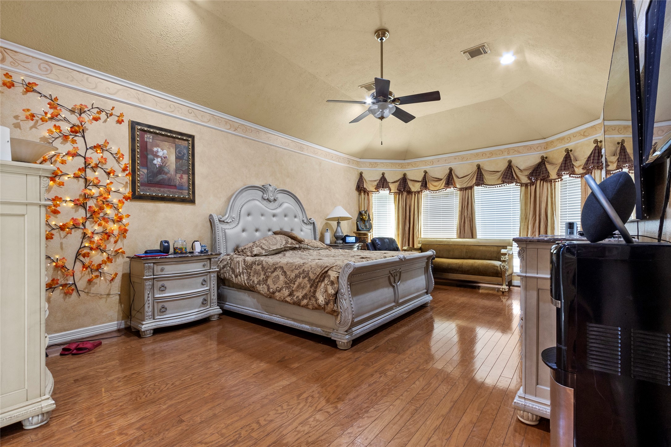 14907 Pine Point Court Houston, TX 77070 - Photo 20 of 33 a bedroom with a bed and a chandelier