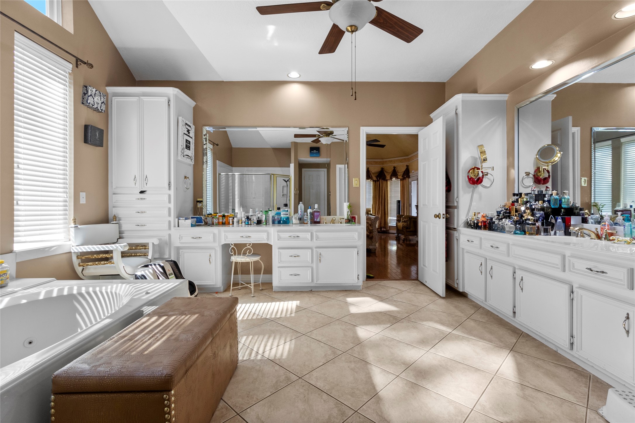 14907 Pine Point Court Houston, TX 77070 - Photo 24 of 33 a large white bathroom with a large tub sink shower and mirror