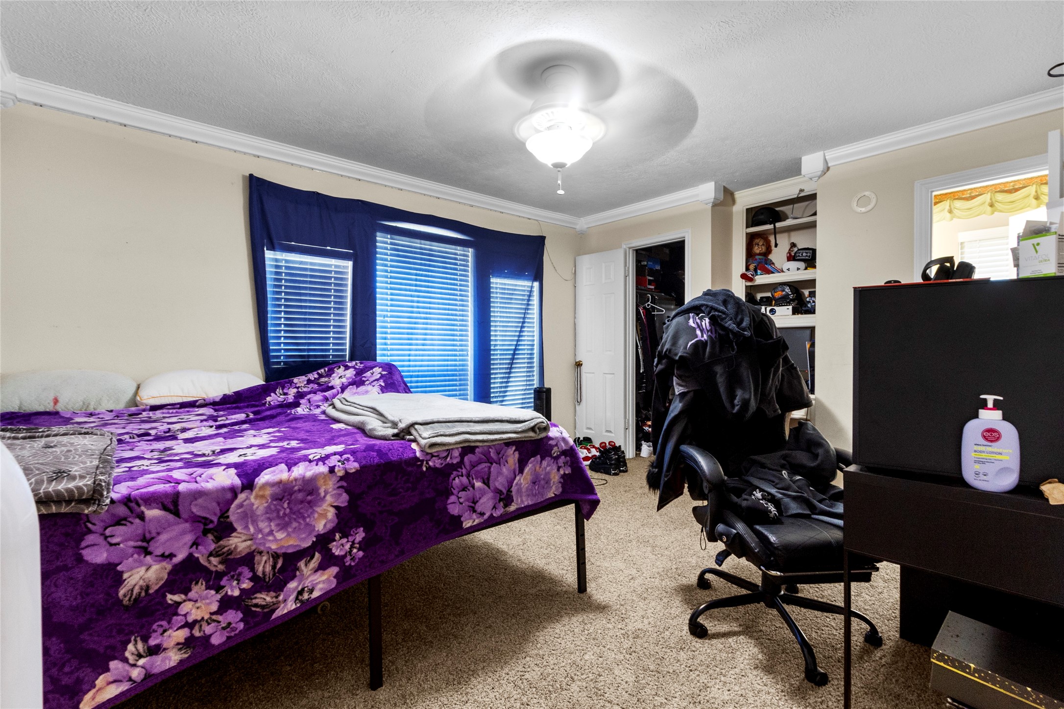14907 Pine Point Court Houston, TX 77070 - Photo 26 of 33 a bedroom with a bed and a flat screen tv