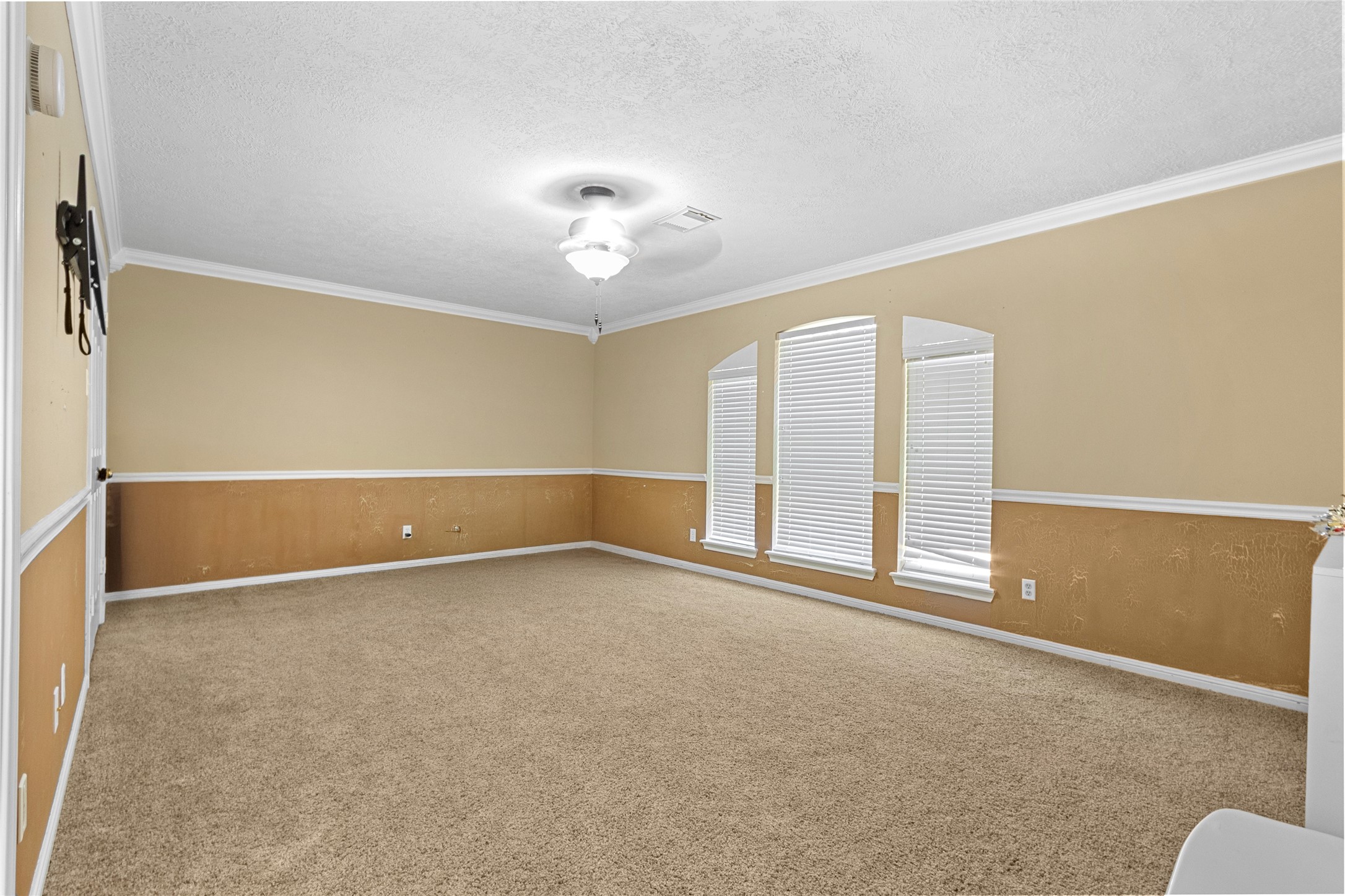14907 Pine Point Court Houston, TX 77070 - Photo 31 of 33 an empty room with windows and chandelier fan
