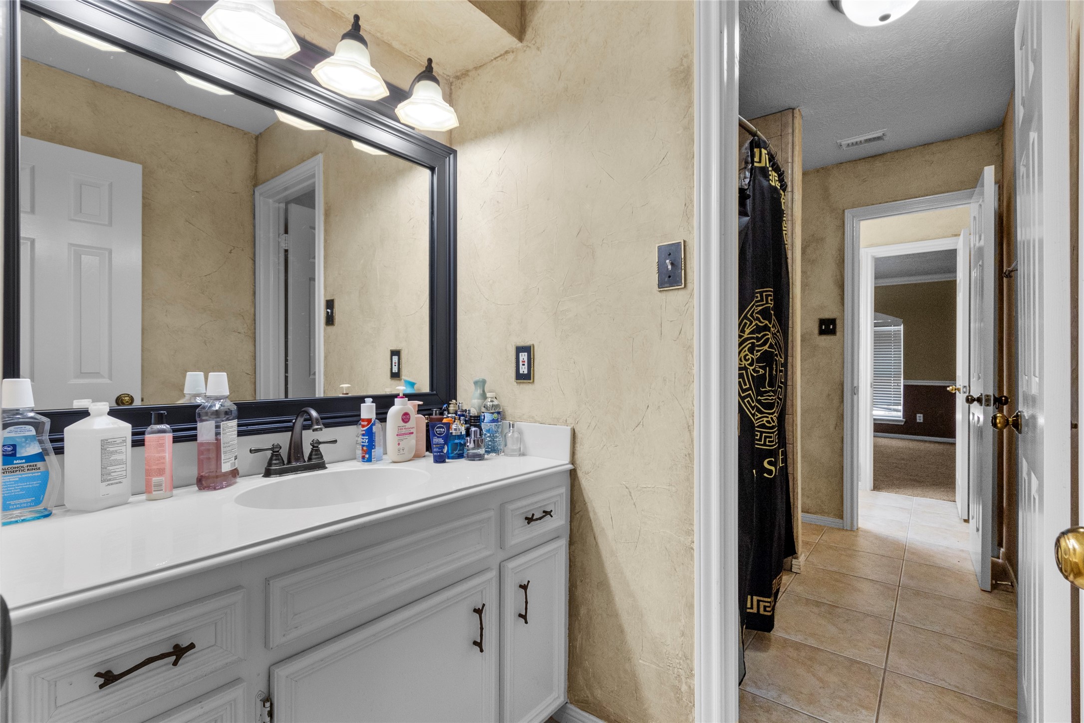 14907 Pine Point Court Houston, TX 77070 - Photo 32 of 33 a bathroom with a sink a large mirror and a shower