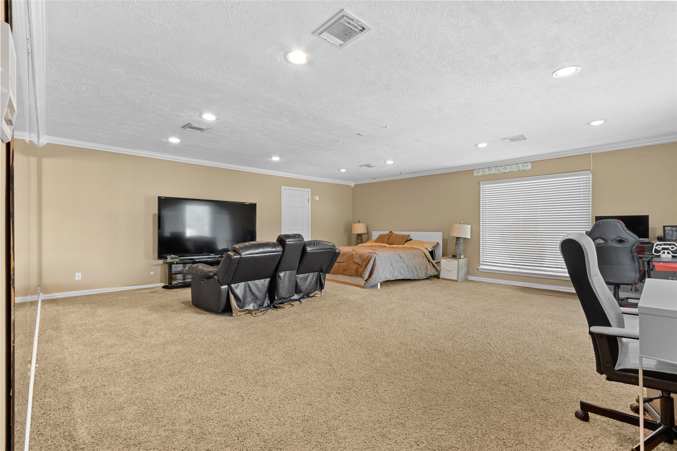14907 Pine Point Court Houston, TX 77070 - Photo 33 of 33 a living room with furniture a flat screen tv and a large window