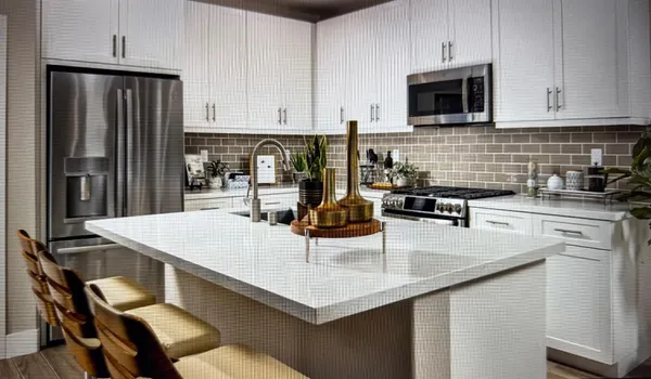 a kitchen with kitchen island granite countertop a sink a stove and refrigerator