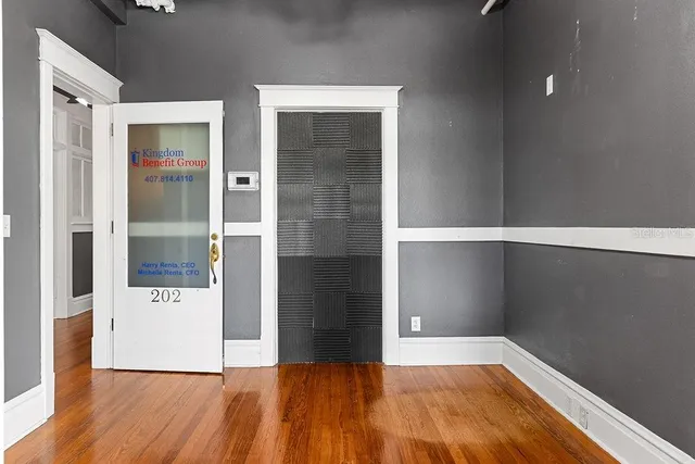 wooden floor in a empty room with a bathroom