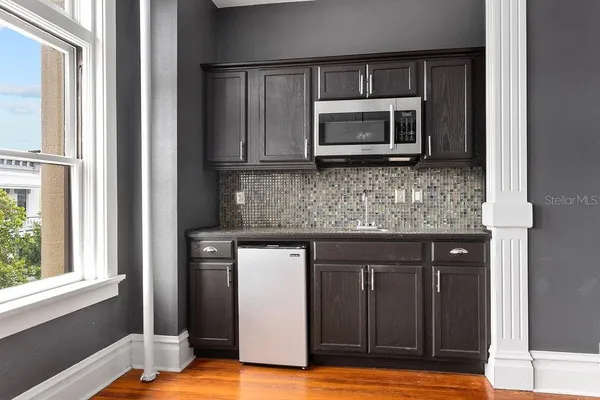 a kitchen with stainless steel appliances granite countertop a stove microwave and refrigerator