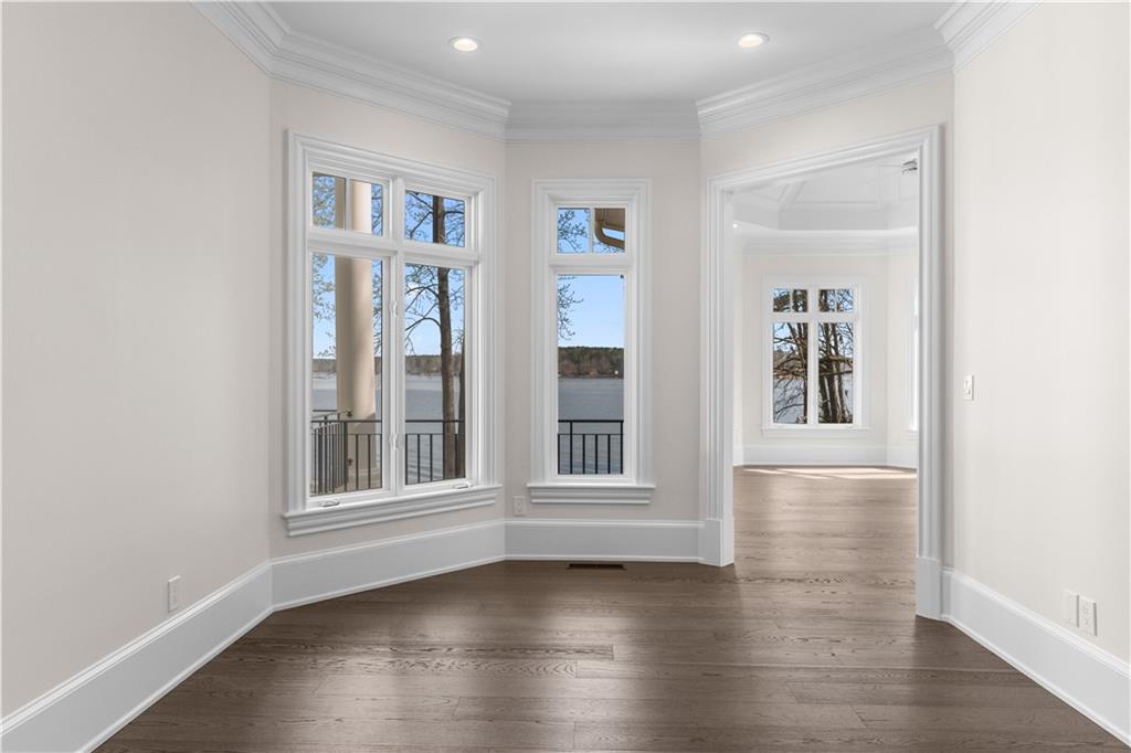 1070 Prosperity Point Greensboro, GA 30642 - Photo 15 of 38 an empty room with wooden floor and windows