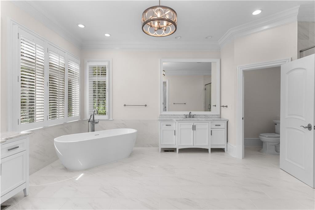 1070 Prosperity Point Greensboro, GA 30642 - Photo 17 of 38 a spacious bathroom with a double vanity sink a mirror and a bathtub