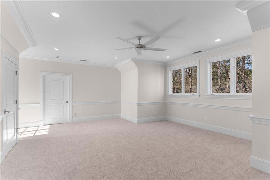 1070 Prosperity Point Greensboro, GA 30642 - Photo 22 of 38 an empty room with windows and ceiling fan