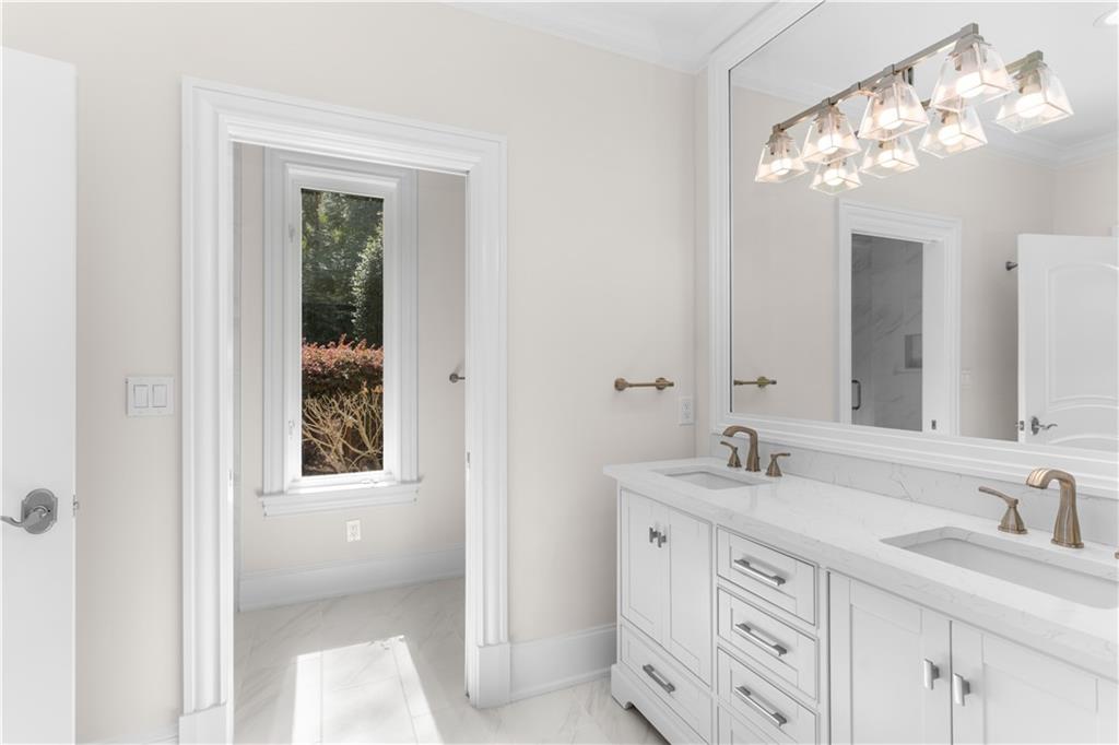 1070 Prosperity Point Greensboro, GA 30642 - Photo 33 of 38 a bathroom with double vanity sink a vanity and a mirror