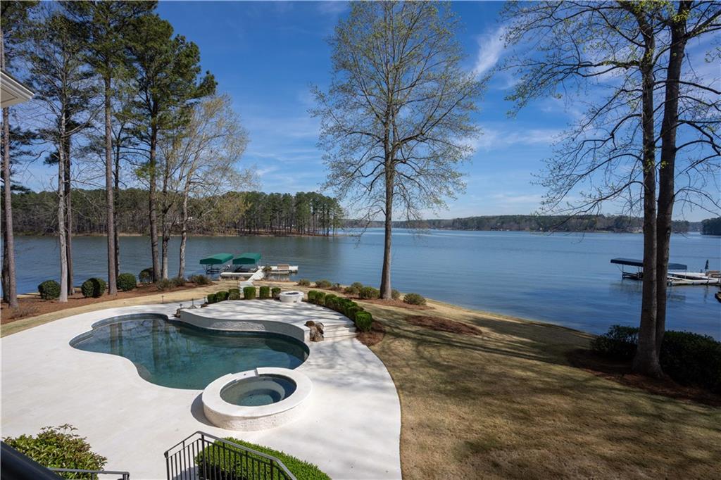 1070 Prosperity Point Greensboro, GA 30642 - Photo 34 of 38 a view of a lake with couches and wooden fence