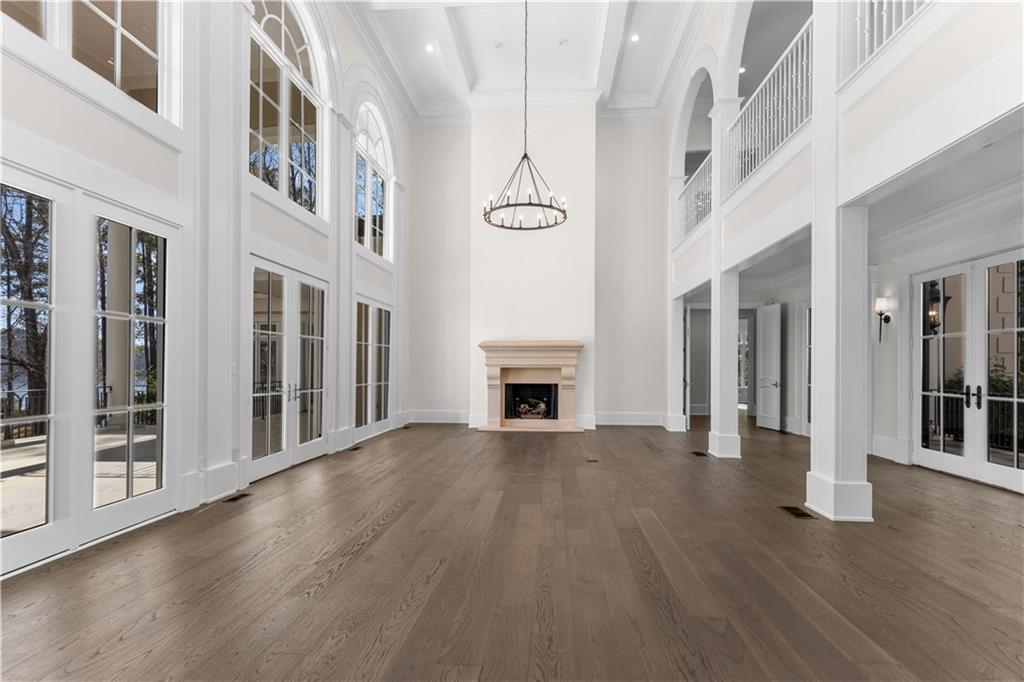 1070 Prosperity Point Greensboro, GA 30642 - Photo 8 of 38 wooden floor in an empty room with a fireplace and wooden floor