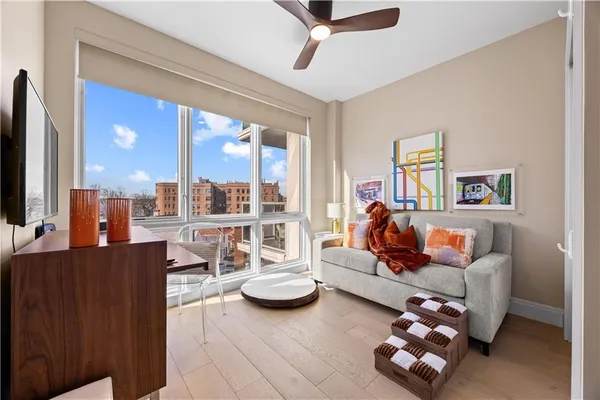 a bedroom with a bed and a large window