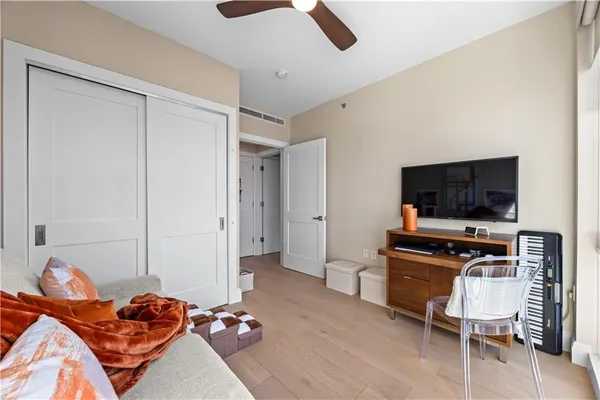 a bedroom with a bed and a flat screen tv