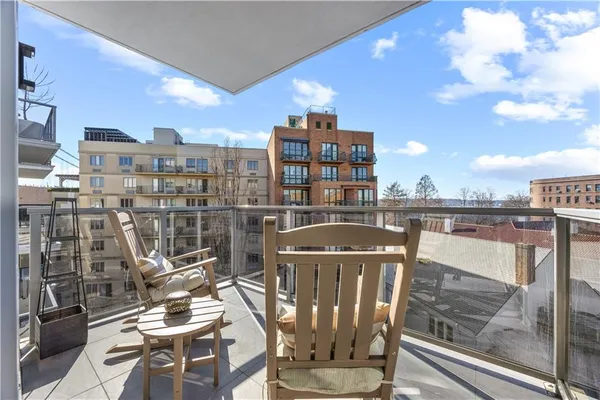 a view of a patio with table and chairs