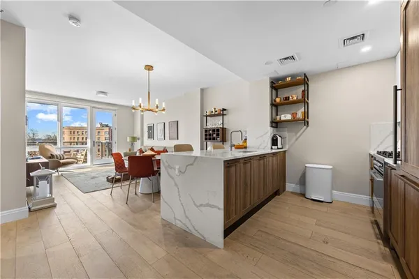 a view of kitchen and white cabinets