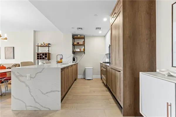 a large kitchen with a sink and cabinets