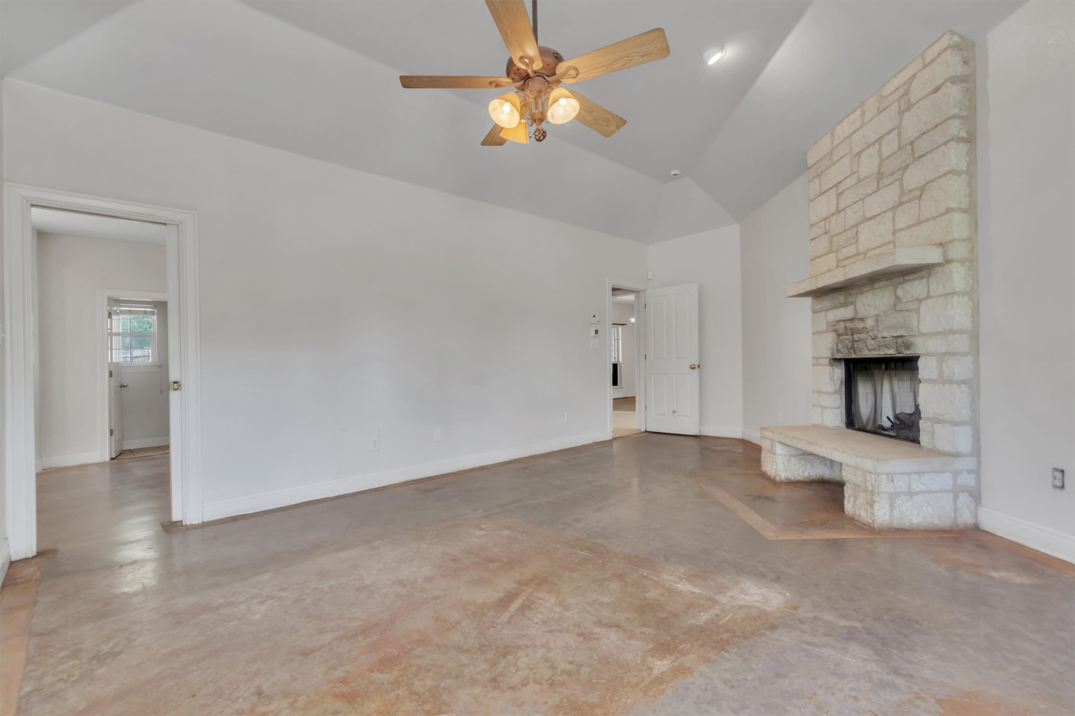 1120 Meadow Ridge Drive Austin, TX 78737 - Photo 17 of 40 A striking stone fireplace and vaulted ceilings define this inviting gathering space.