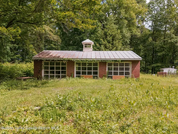 a view of a house with a backyard and a garden