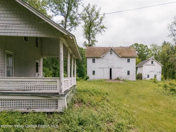 a view of a house with a yard and wooden fence