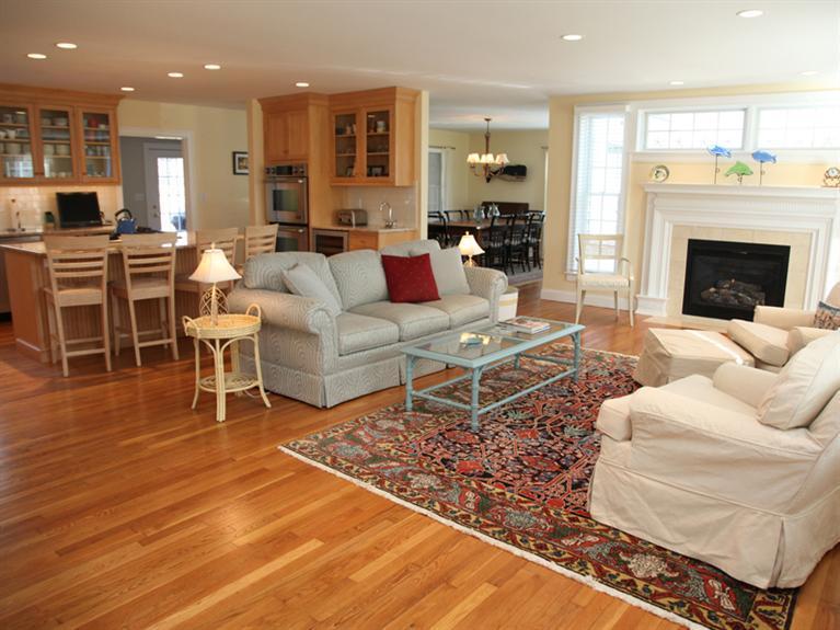 69 Goodview Way Barnstable, MA 02630 - Photo 2 of 17 a living room with furniture wooden floor and a fireplace