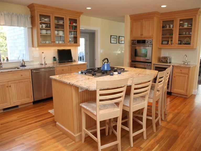 69 Goodview Way Barnstable, MA 02630 - Photo 5 of 17 a kitchen with stainless steel appliances kitchen island granite countertop a table chairs sink and cabinets