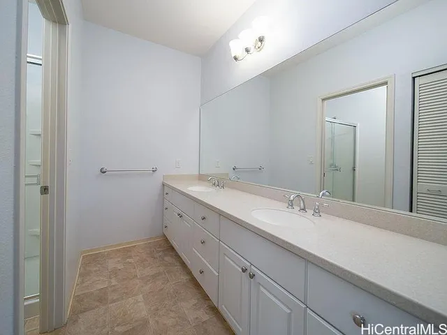 a bathroom with double sink and mirror