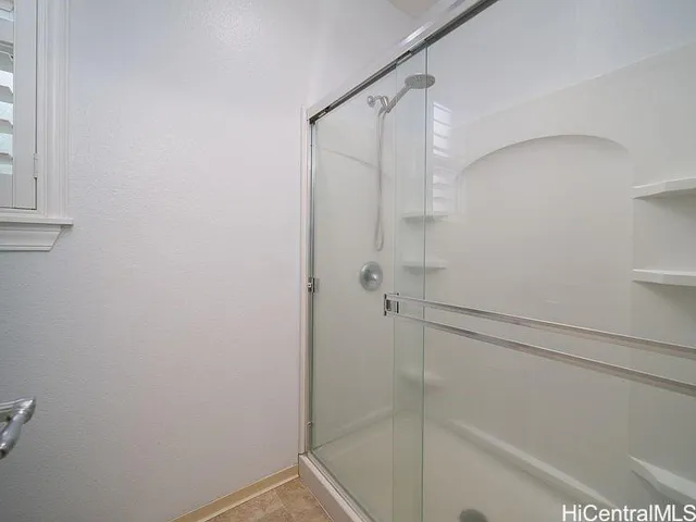 a bathroom with a glass shower door