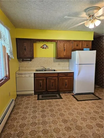 a kitchen with a stove top oven cabinets and a refrigerator