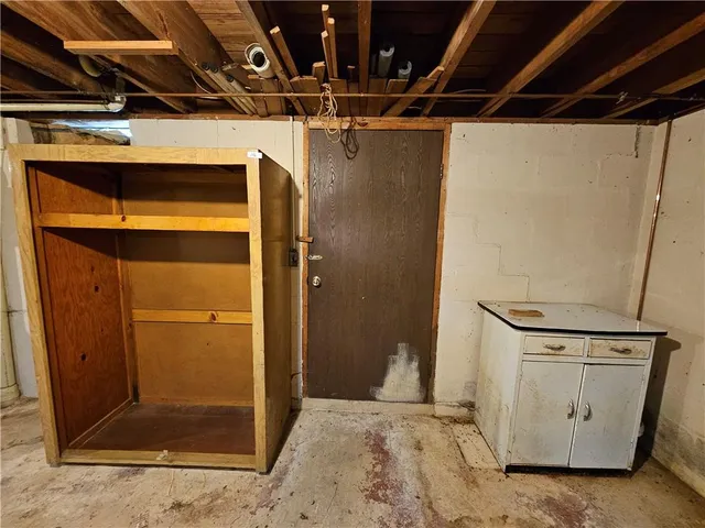 a utility room with stainless steel appliances kitchen island granite countertop a refrigerator and a stove