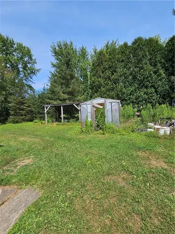 a view of a yard with a house in the background